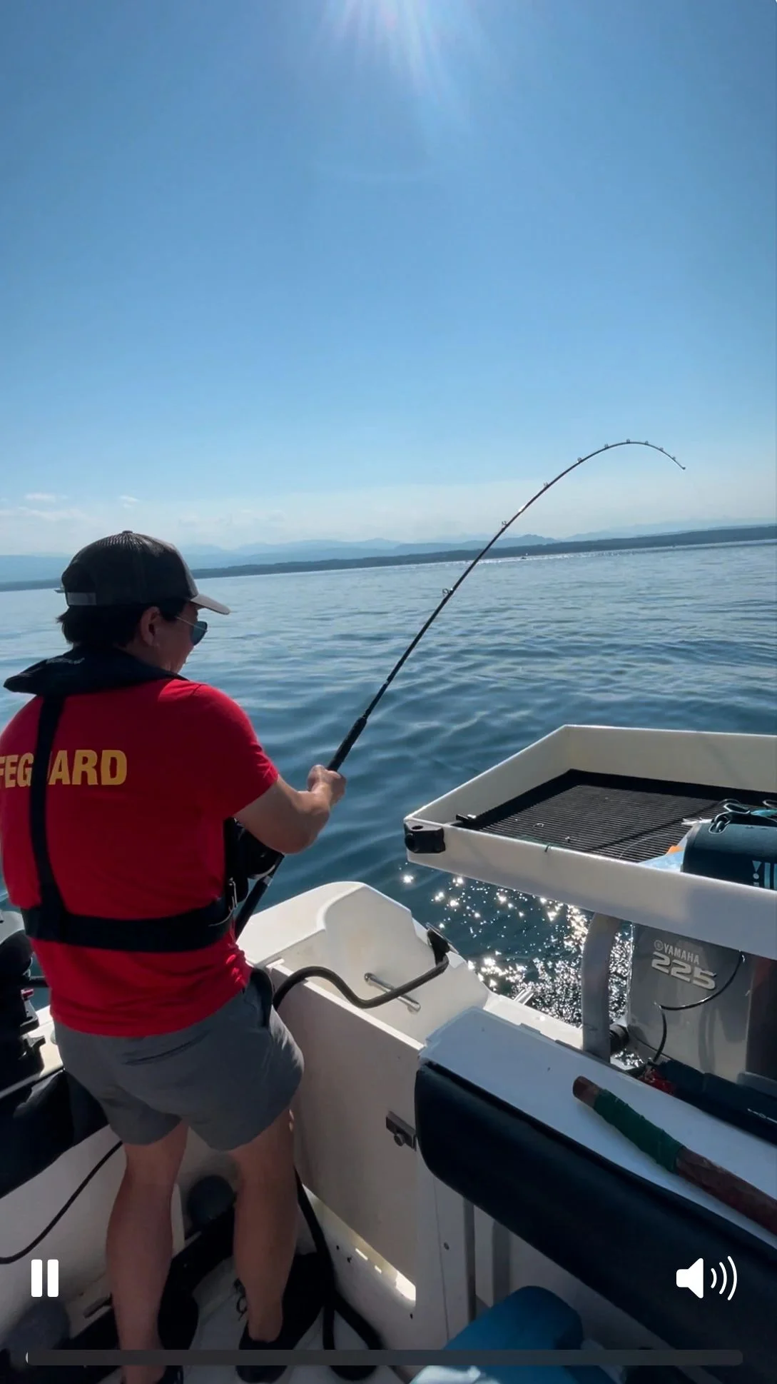 Angler Fighting Fish in Calm Waters