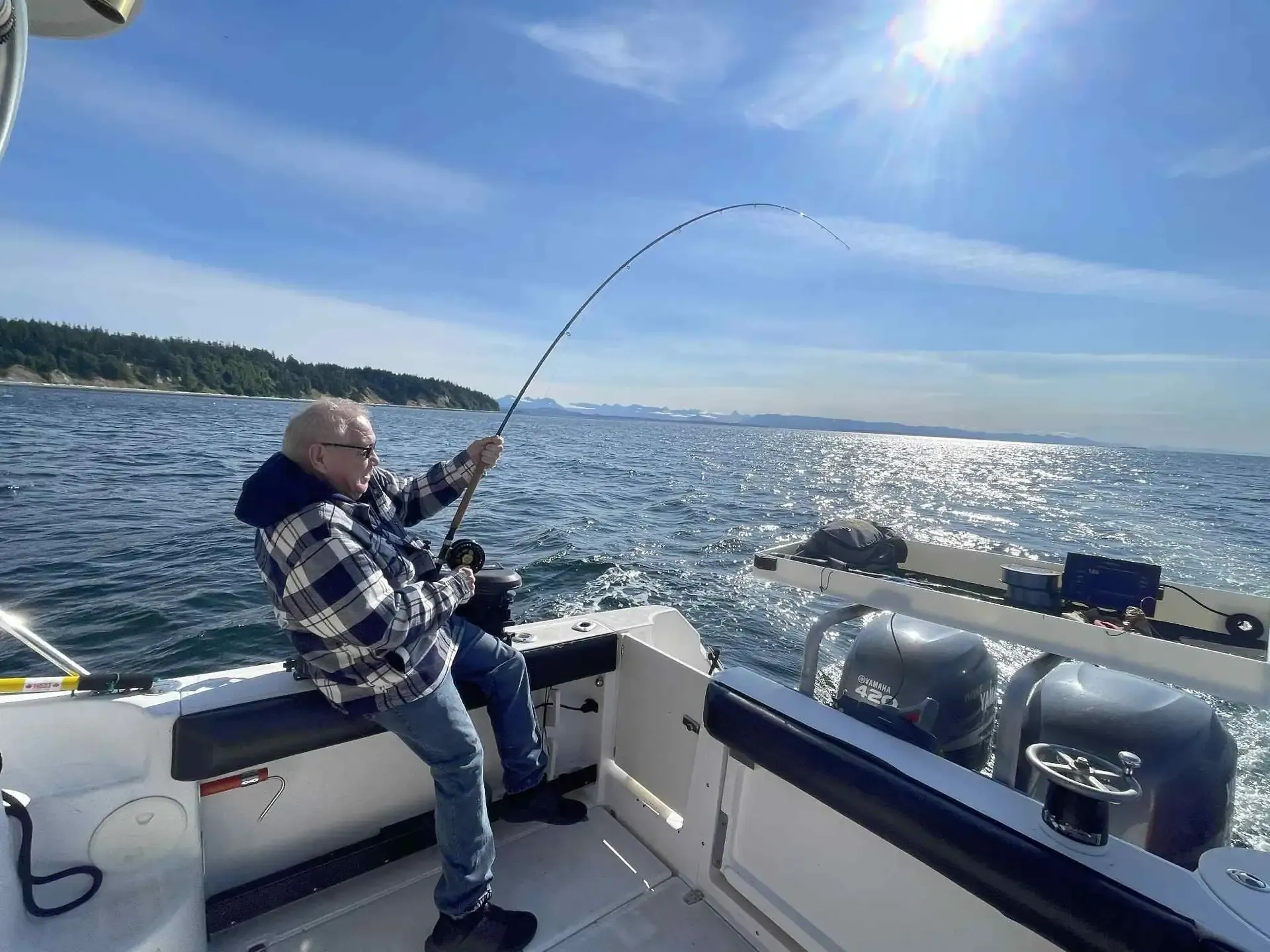 Angler fighting salmon action shot