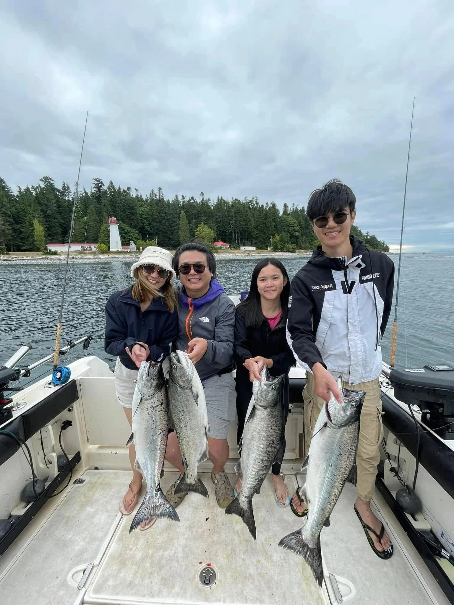 Asian Family with Salmon near Lighthouse